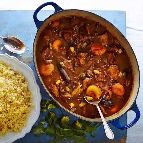 meat with dried apricots and dried plums in a blue dish