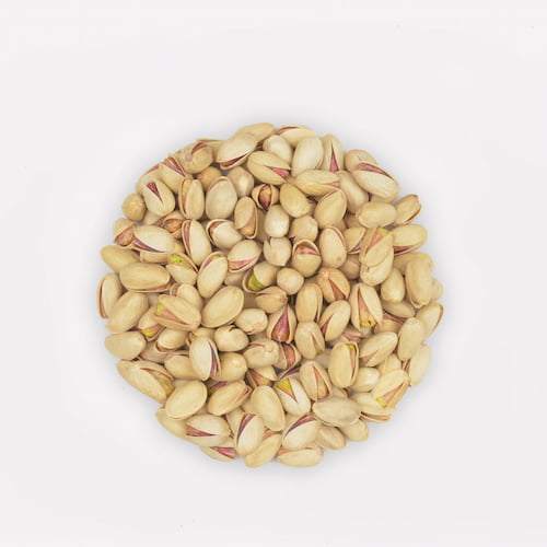 long pistachio (ahmad aghayee) in a wooden bowl on white background